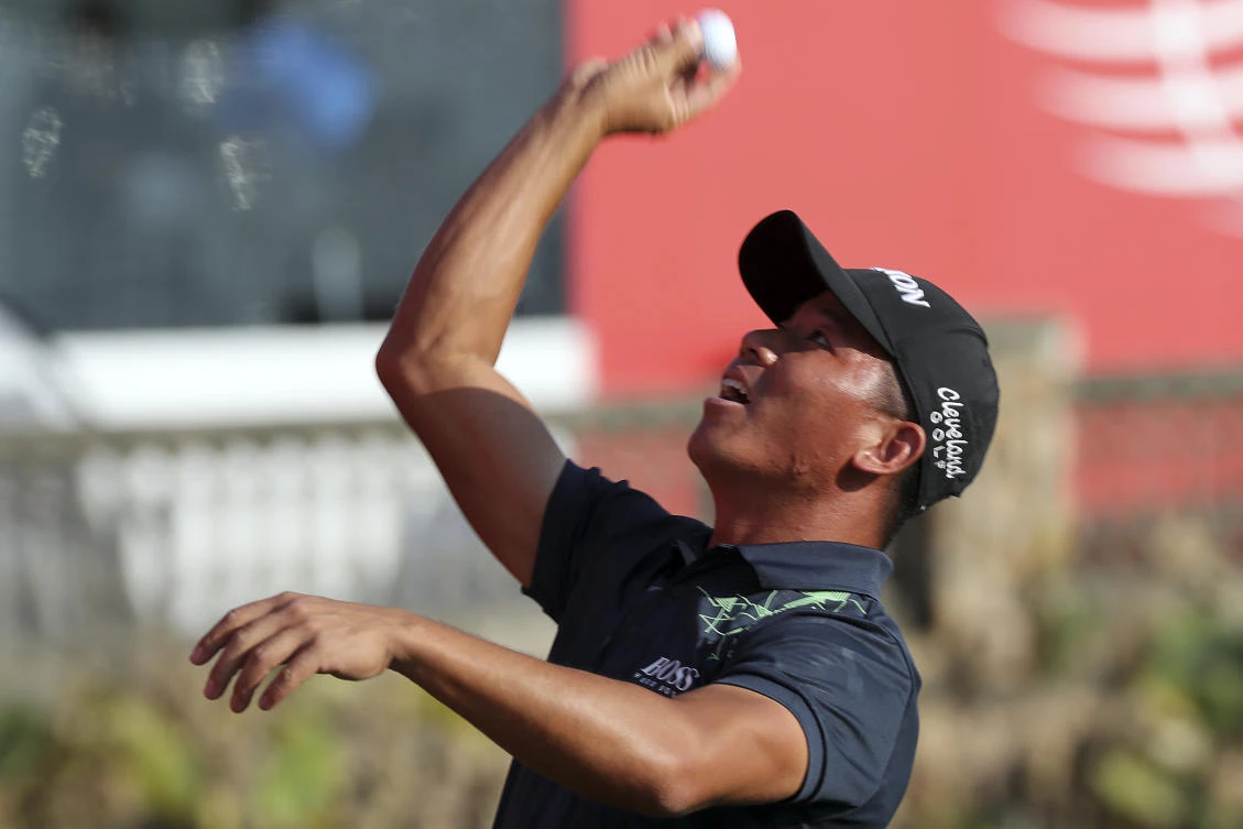 Wu Ashun of China throws a golf ball to his fans after round three of the 2017 WGC-HSBC Champions golf tournament held at the Sheshan International Golf Club in Shanghai, China, Saturday, Oct. 28, 2017. (AP/Ng Han Guan)