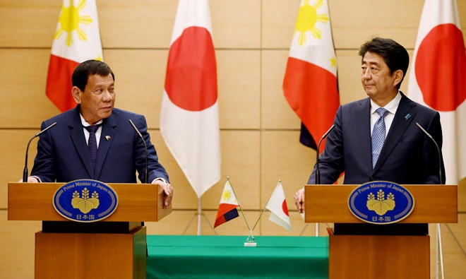 Philippine President Rodrigo Duterte delivers his speech beside Japanese Prime Minister Shinzo Abe during the joint remarks announcement at Abe's official residence in Tokyo on Monday. (Reuters)