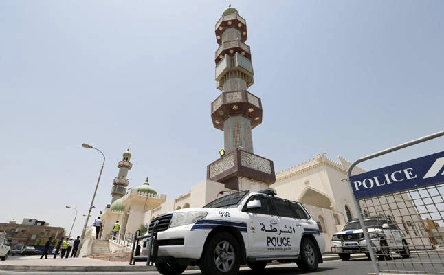 In this file photo, police vehicles are parked outside a mosque in Manama, Bahrain. A Bahraini court on Monday sentenced 19 Shiites to lengthy jail terms on charges of spying for Iran and plotting to overthrow the regime. (Reuters file photo)