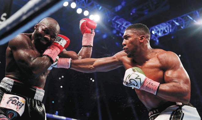 Anthony Joshua lands a right hand on Carlos Takam. (AFP)