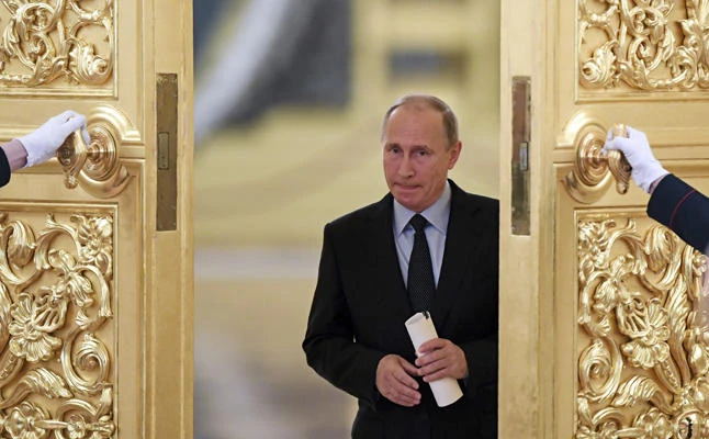Russian President Vladimir Putin enters a hall to meet members of the Presidential Council for Civil Society and Human Rights at the Kremlin in Moscow on Oct. 30, 2017. (Kirill Kudryavtsev/Pool photo via AP)