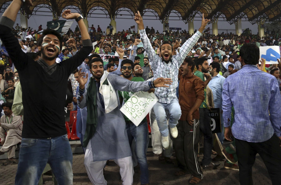 Cricket fans dance during the third Twenty20 international match between Pakistan and Sri Lanka at the Qaddafi stadium in Lahore, Pakistan, Sunday, Oct. 29, 2017. (AP/K.M. Chaudary)
