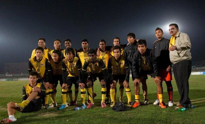 Members of Malaysia’s football team pose for the media after playing their qualifying match for the 2012 London Olympic Games against Pakistan, in Lahore on March 9, 2011. (File photo by Reuters)