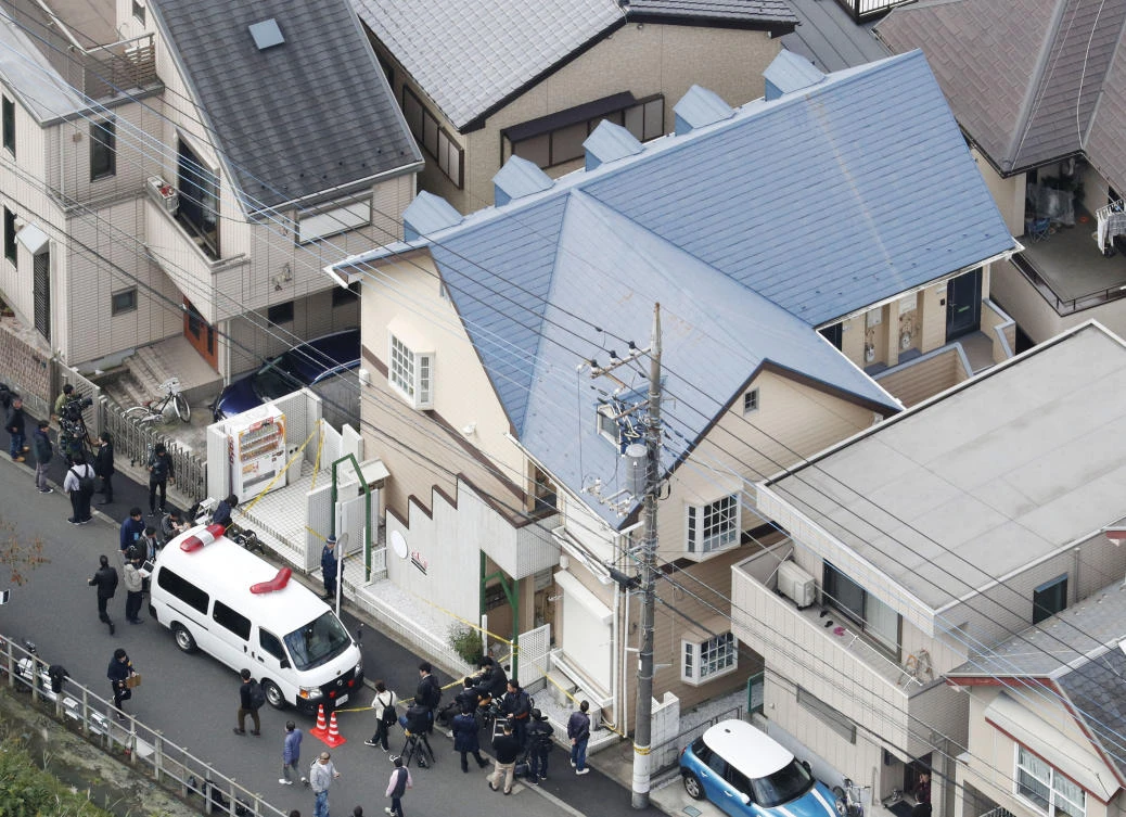 This aerial photo shows the apartment, center, where police found dismembered bodies in coolers in Zama city, southwest of Tokyo, Tuesday, Oct. 31, 2017. A police spokesman said Tuesday the 27-year-old suspect confessed to cutting up the bodies and hiding them in cold-storage cases, covered with cat litter. (Kyodo News via AP)