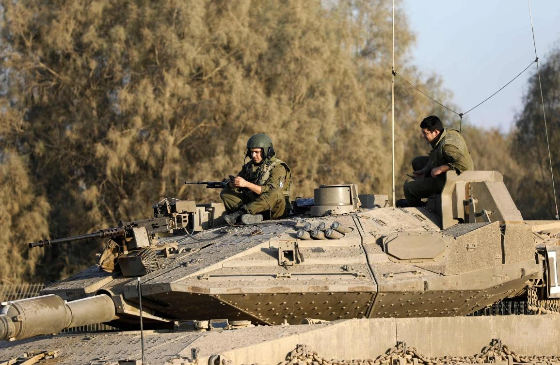 Israeli soldiers sit on a tank close to the Israeli border with the Gaza Strip on Oct. 30, 2017, near Kibbutz Kissufim in southern Israel. (AFP/Menahem Kahana)