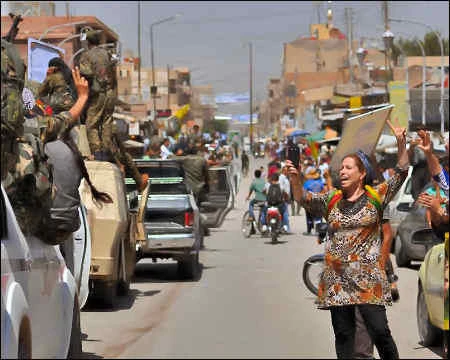 Residents welcome fighters in Qamishlo, the Kurds’ biggest city in Syria. (AFP)