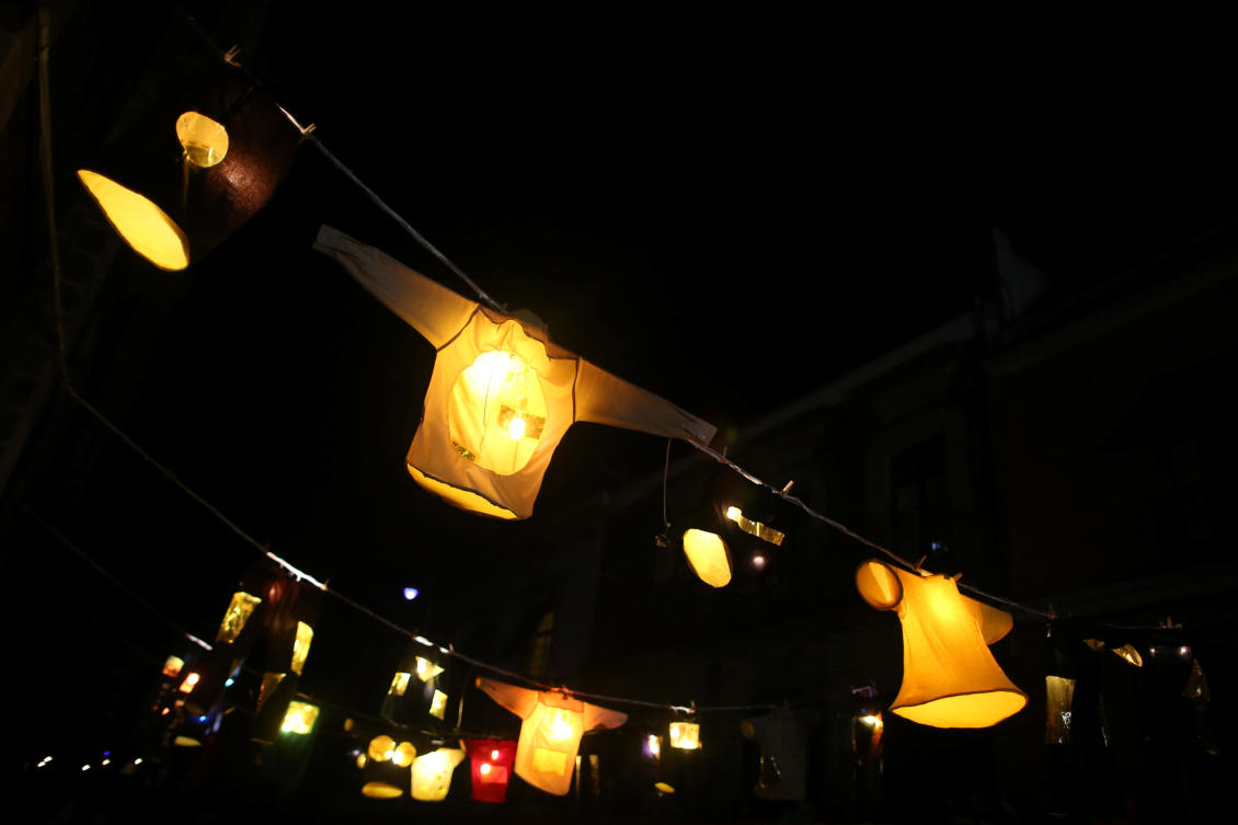 Clothing is illuminated as it hangs from ropes during the International Festival of Lights in Mexico City, Mexico, November 16, 2017. REUTERS/Edgard Garrido NO RESALES. NO ARCHIVES.
