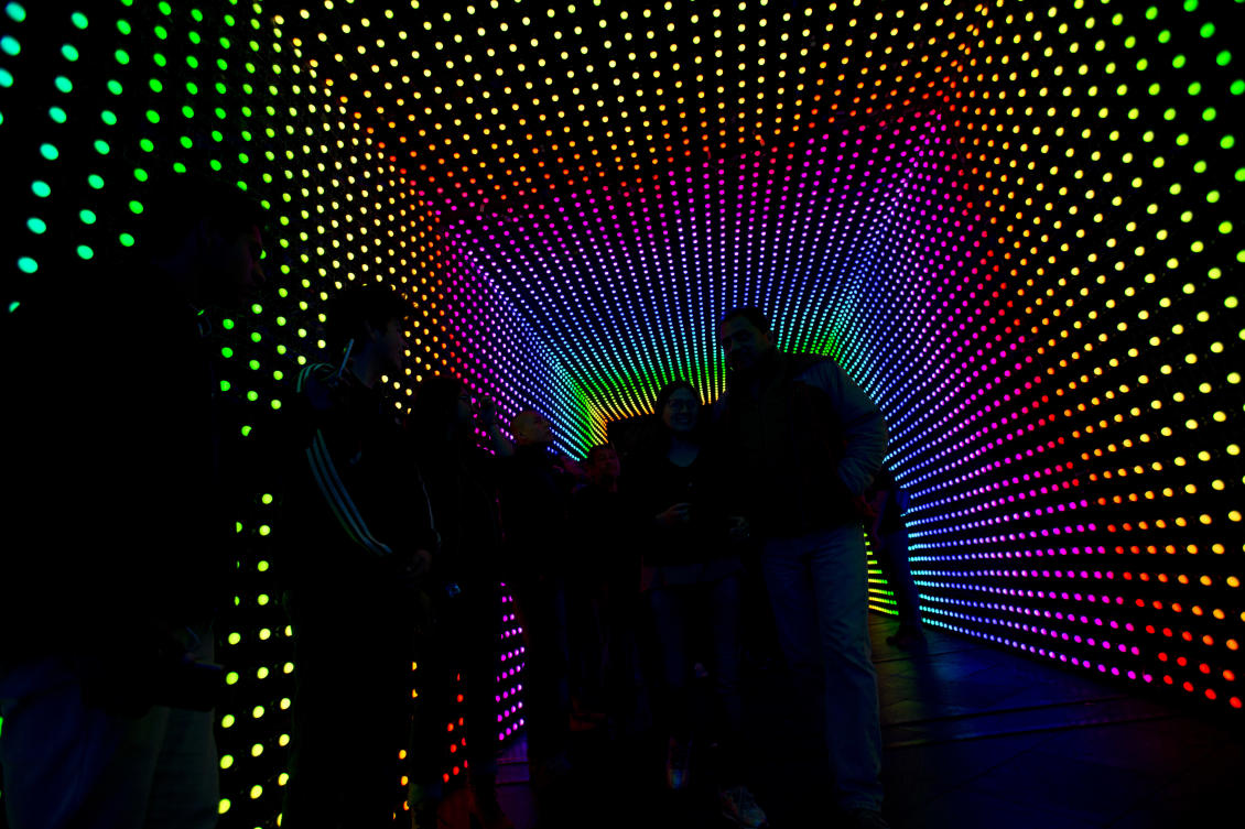 Visitors walk through a tunnel lit by artists specializing in traditional Mexican lighting methods, in a work entitled "Dinamismo CDMX," at the International Festival of Lights in Mexico City, Friday, Nov. 17, 2017. This years festival, featuring installations and projections, is lighting up the capital's historic center until Nov. 19.(AP Photo/Rebecca Blackwell)