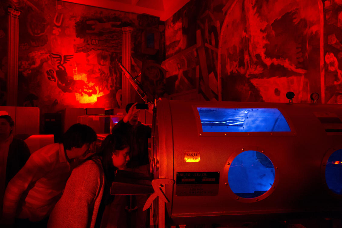 Visitors peer into a work entitled "The Elementary Revolutions " by Argentine artist Marcelo Schuster, part of the International Festival of Lights in Mexico City, Friday, Nov. 17, 2017. This years festival, featuring installations and projections, is lighting up the capital's historic center until Nov. 19. (AP Photo/Rebecca Blackwell)