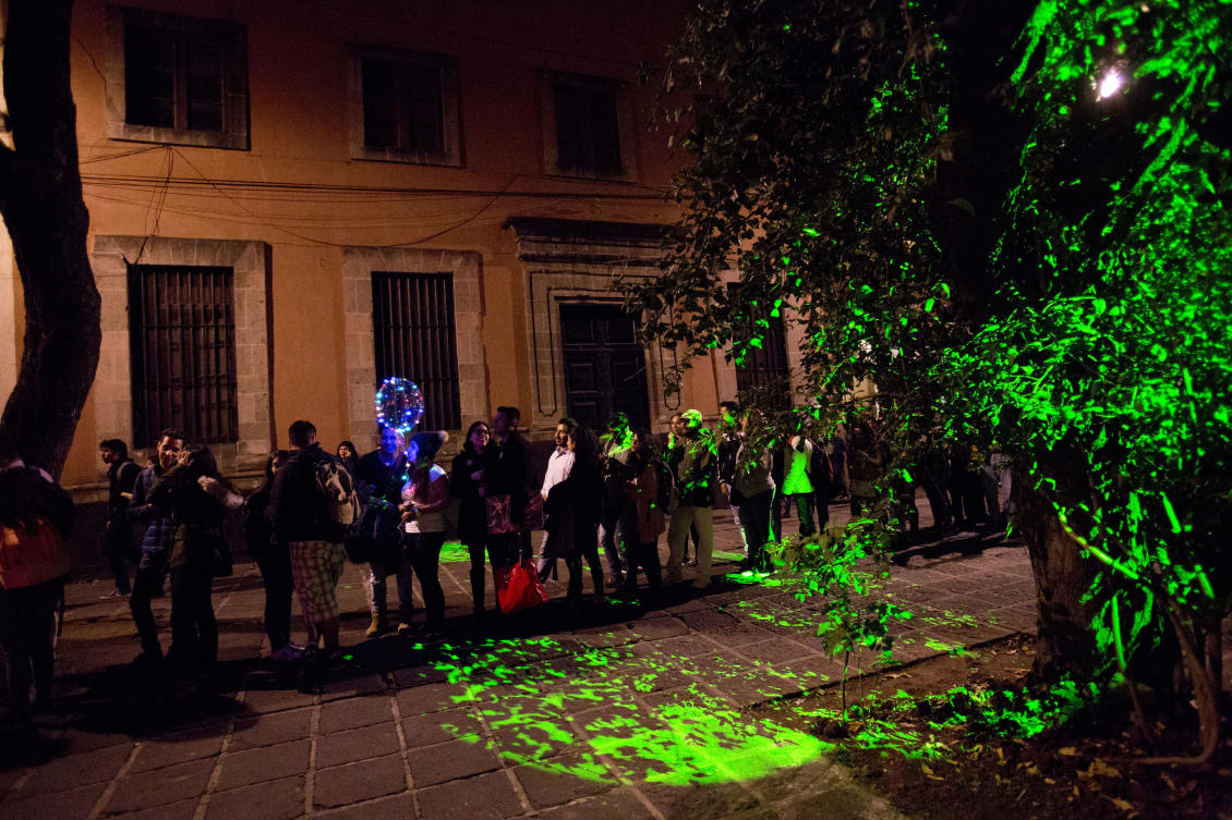 Visitors wait in line to view "1.8" by American artist Janet Echelman, part of the International Festival of Lights in Mexico City, Friday, Nov. 17, 2017. This year's festival, featuring installations and projections, is lighting up the capital's historic center until Nov. 19.(AP Photo/Rebecca Blackwell)