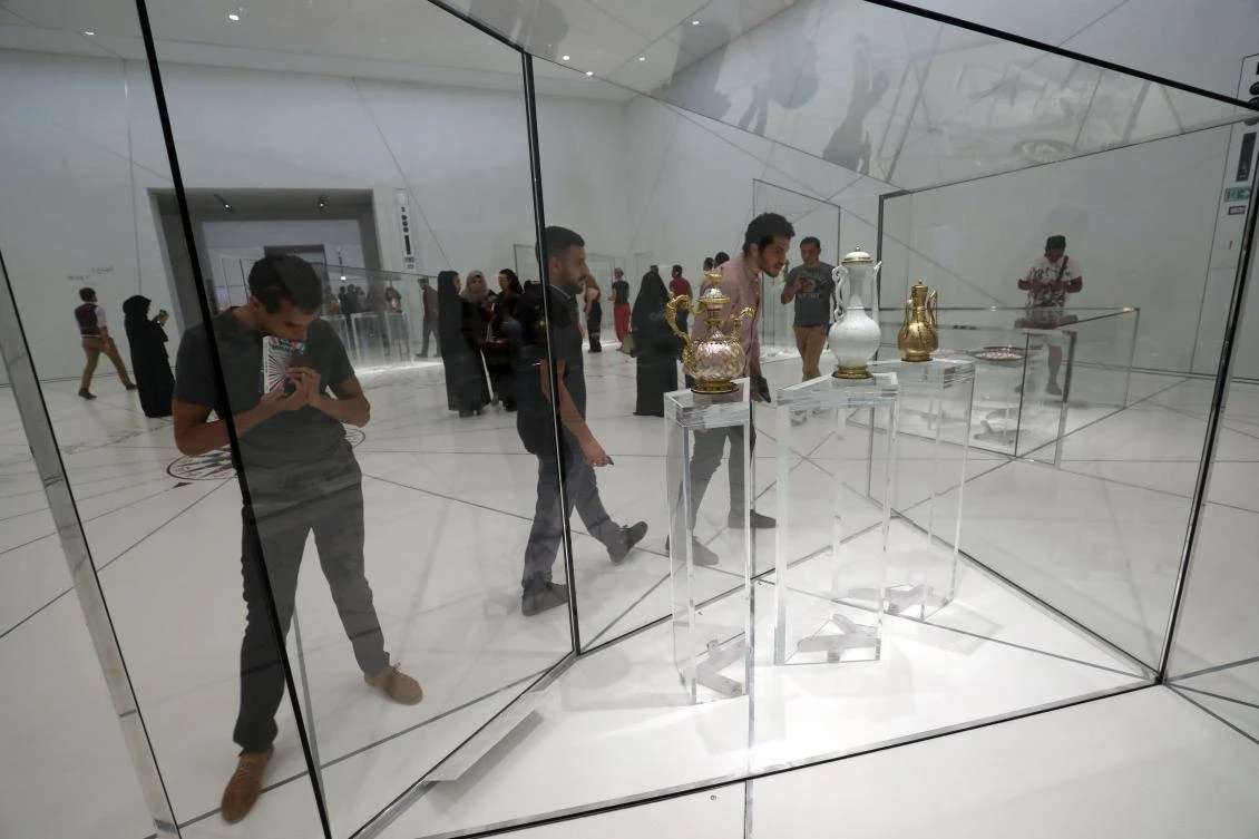 Visitors look at exhibits during the opening of the Louvre Abu Dhabi Museum on November 11, 2017 on Saadiyat island in the Emirati capital. / AFP / KARIM SAHIB