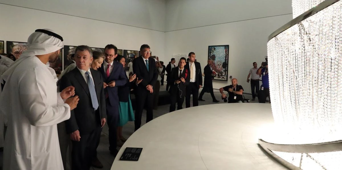 President of Colombia Juan Manuel Santos (2nd-L) and his wife Maria (3rd-L) are escorted by Mohamad Khalifa al-Mubarak (L), the chariman of Abu Dhabi tourism and culture authority, during the opening of the Louvre Abu Dhabi Museum on November 11, 2017 on Saadiyat island in the Emirati capital. / AFP / KARIM SAHIB