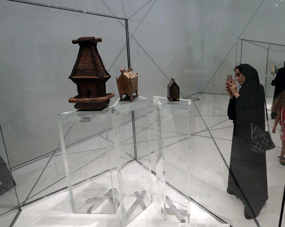 Visitors look at exhibits during the opening of the Louvre Abu Dhabi Museum on November 11, 2017 on Saadiyat island in the Emirati capital. / AFP / KARIM SAHIB