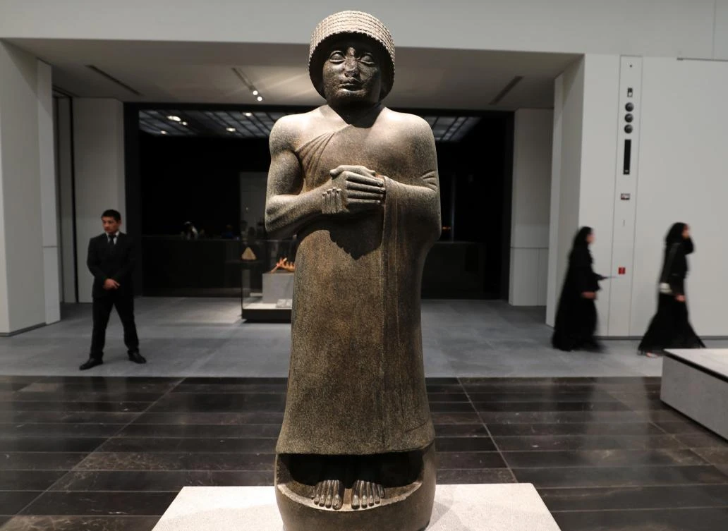 A statue of Gudea, prince of the independent kingdom of Lagash in the late 3rd millennium, is pictured during the opening of the Louvre Abu Dhabi Museum on November 11, 2017 on Saadiyat island in the Emirati capital. / AFP / KARIM SAHIB