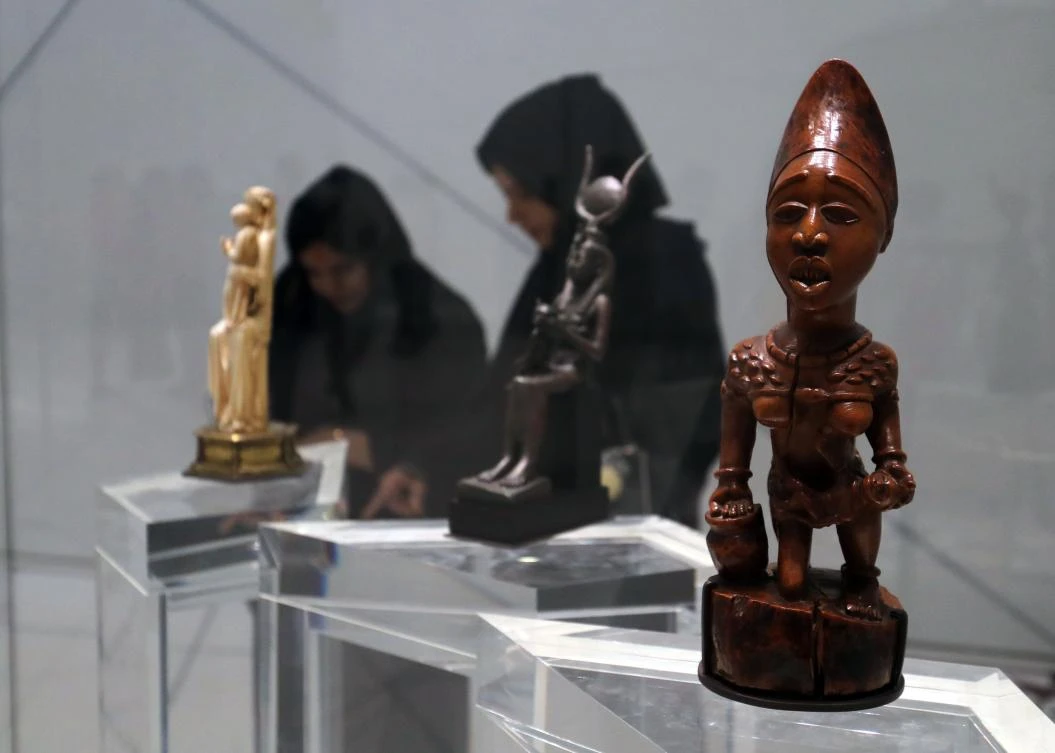 Visitors look at exhibits during the opening of the Louvre Abu Dhabi Museum on November 11, 2017 on Saadiyat island in the Emirati capital. / AFP / KARIM SAHIB