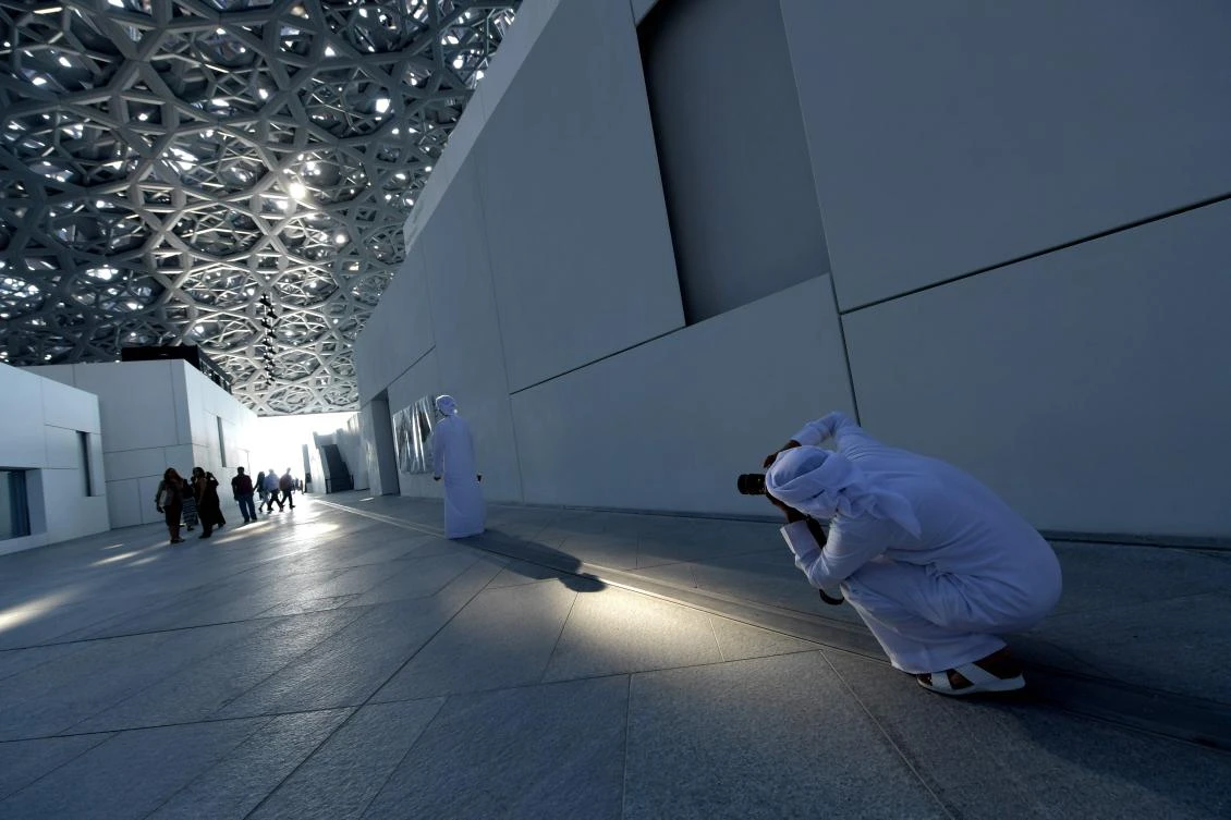 Visitors tour the Louvre Abu Dhabi Museum on November 11, 2017 during its official opening to the public on Saadiyat island in the Emirati capital. More than a decade in the making, the Louvre Abu Dhabi opened its doors bringing the famed name to the Arab world for the first time. - / AFP / GIUSEPPE CACACE