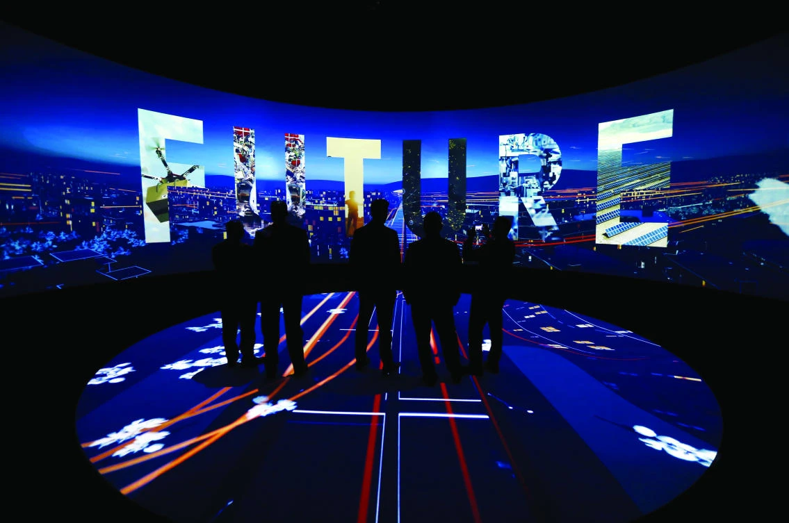Visitors watch a 3-D presentation during an exhibition on ‘Neom,’ a new business and industrial city, in Riyadh. (Reuters)