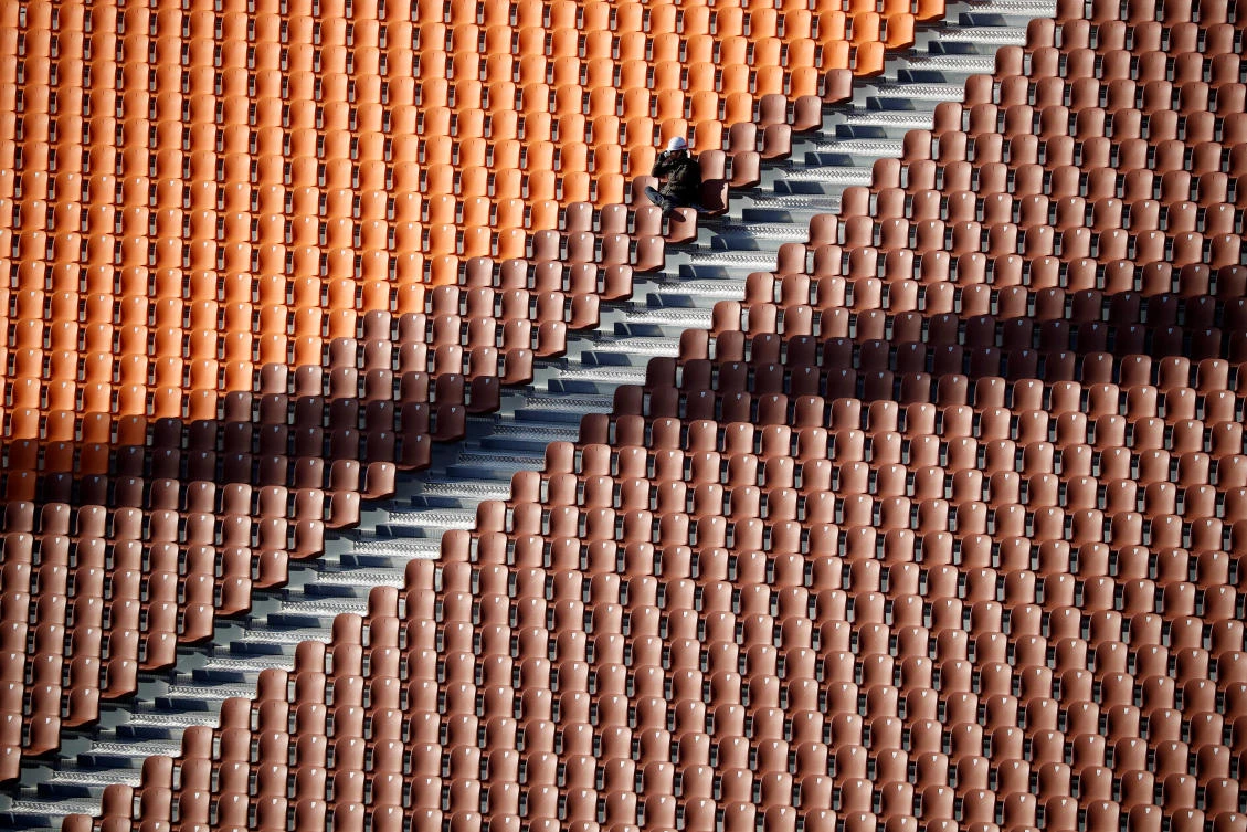 A worker rests at the Olympic Plaza, the venue for the opening and closing ceremony of the PyeongChang 2018 Winter Olympic Games, in Pyeongchang, South Korea, Oct. 30, 2017. (Reuters/Kim Hong-Ji)
