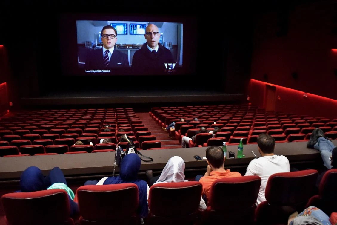 People sit in the screening room as they wait for the start of a movie at the Majestic cinema in Abidjan. The new cinema complexes tend to give precedence to Hollywood blockbusters rather than films made by African directors. (AFP)