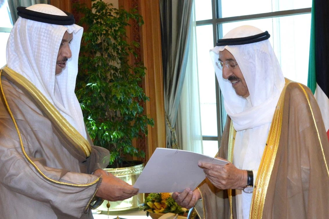 A handout photo provided by the Kuwaiti news agency KUNA shows Kuwaiti Prime Minister Sheikh Jaber Al-Mubarak Al-Sabah (L) handing over the government’s resignation letter to the Emir of Kuwait Sheikh Sabah Al-Ahmad Al-Sabah on Oct. 30, 2017, in Kuwait City. (AFP Photo/HO/KUNA)