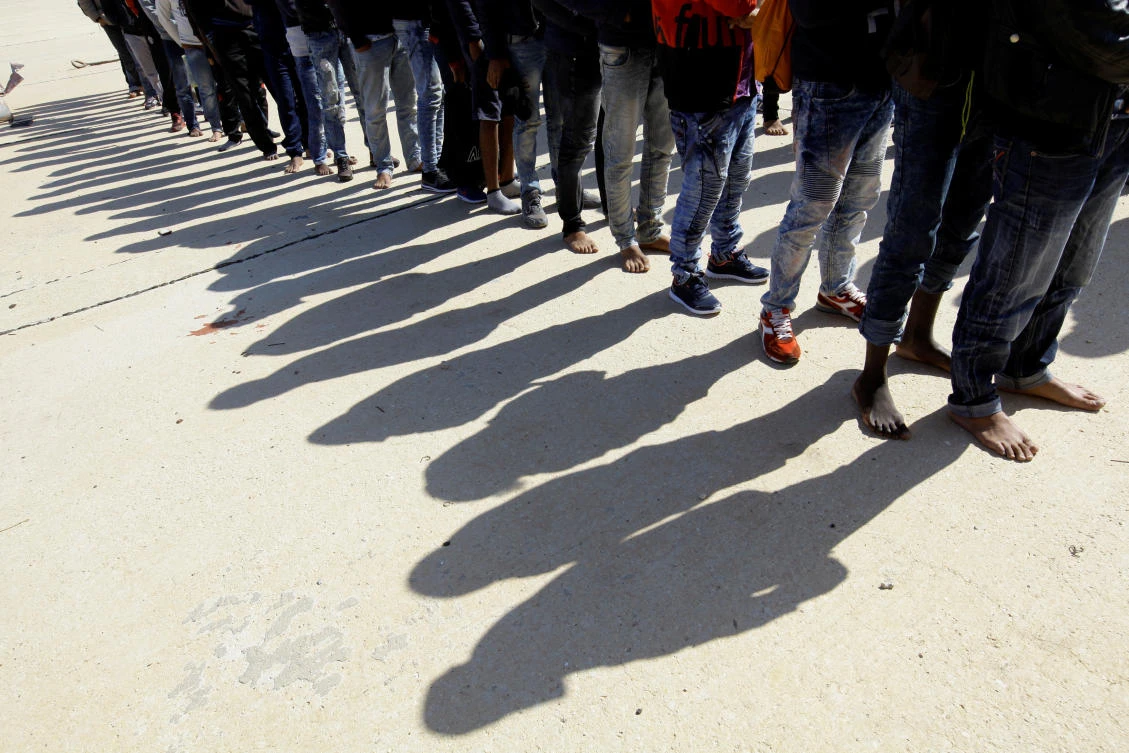 This file photo shows migrants standing at a naval base after they were rescued by Libyan coast guard, in Tripoli, Libya Oct. 18, 2017. (Reuters/Ismail Zitouny)