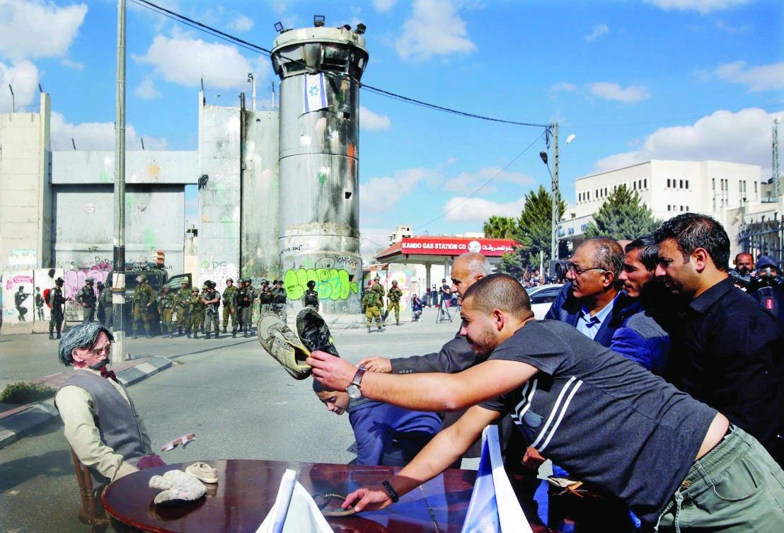 Palestinians throw shoes at an effigy depicting Arthur Balfour during a protest in the West Bank city of Bethlehem on Wednesday. (Reuters)