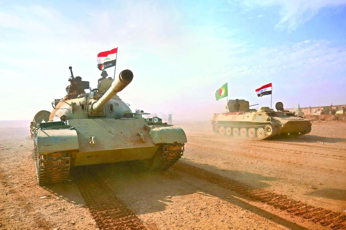 Iraqi forces and Popular Mobilization Forces advance toward the city of Al-Qaim as they fight against Daesh on Wednesday. (AFP)