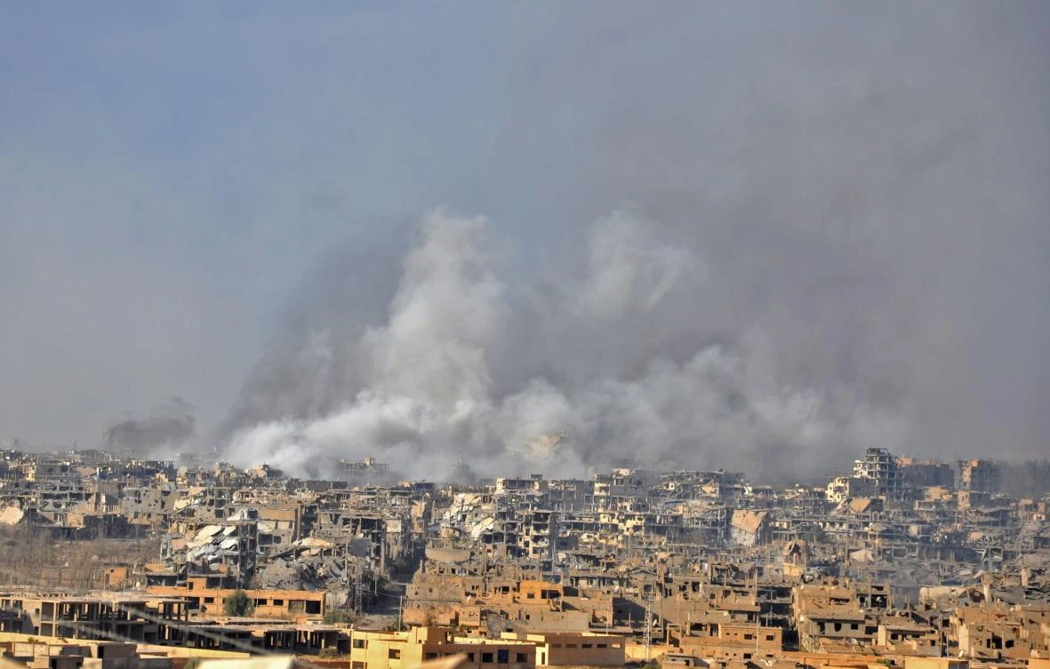 This file photo taken on Oct. 31, 2017 shows smoke rising from buildings following an air strike by Syrian government forces in the eastern city of Deir Ezzor, during an operation against Daesh jihadists. (AFP)