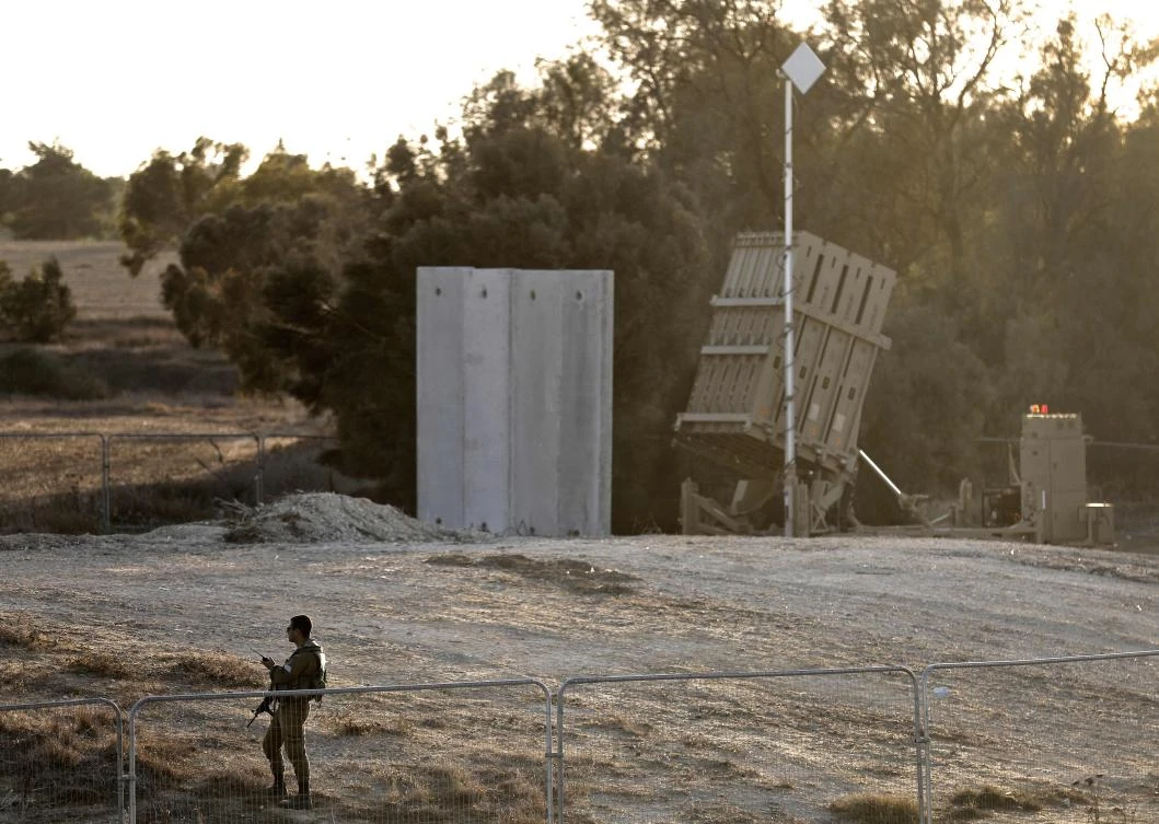 An Israeli soldier stands guard next to Israel’s Iron Dome defense system, designed to intercept and destroy incoming short-range rockets and artillery shells, deployed close to the Israeli border with the Gaza Strip, near Kibbutz Kissufim in southern Israel, on October 30, 2017. A Palestinian was killed and nine others injured when Israel blew up a tunnel stretching from the Gaza Strip into its territory, the health ministry in the Hamas-run enclave said. (AFP/Menahem Kahana)