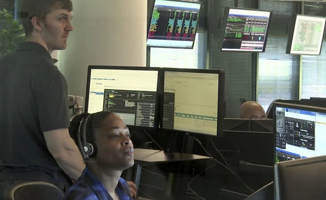 Seen though an interior window, employees work in the offices of Secureworks in Atlanta on Oct. 4, 2017. Nineteen thousand lines of targeting data obtained from threat intelligence firm Secureworks lays out in unprecedented detail who the hackers tried to compromise, providing a minute-by-minute look at how the group often dubbed "Fancy Bear" penetrated the Democratic National Committee, tried to break into the Clinton campaign and eventually stole chairman John Podesta's emails. (AP Photo/Marina Hutchinson)