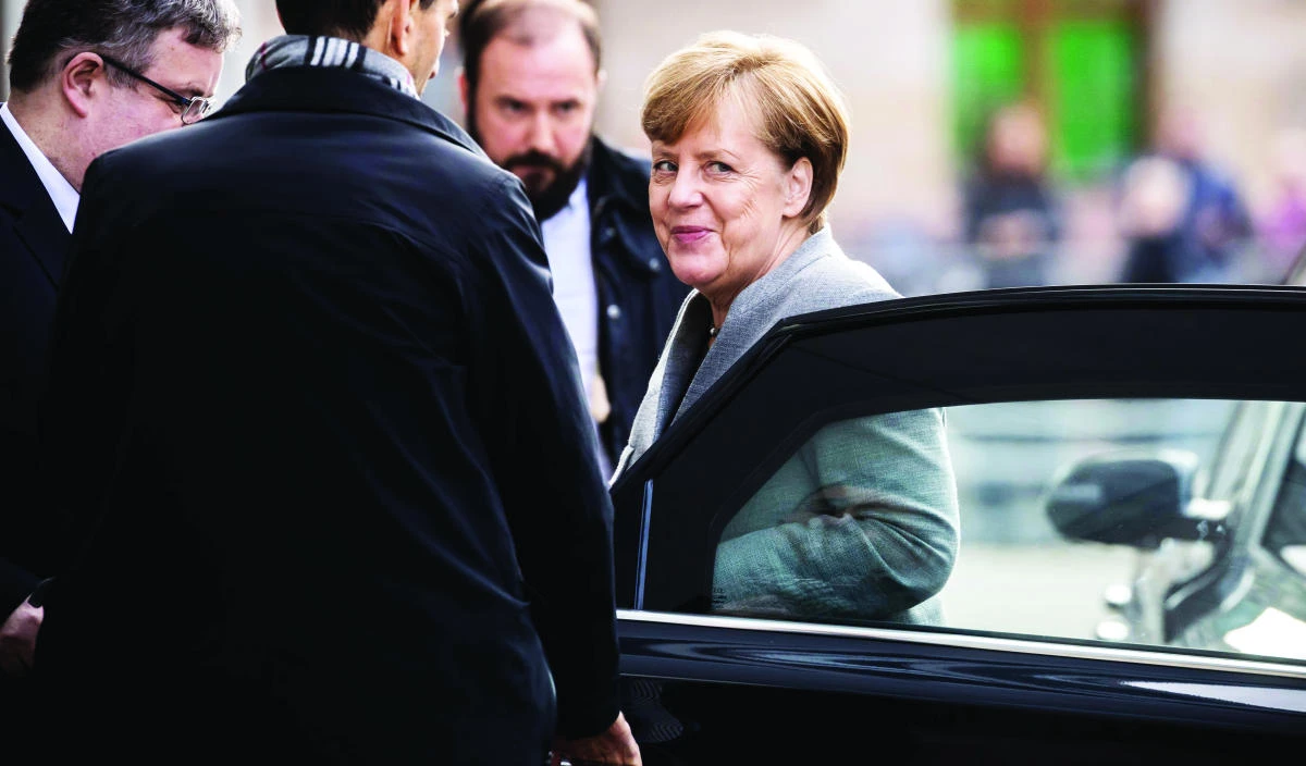 German Chancellor and leader of the Christian Democratic Union (CDU) party, Angela Merkel arrives in Berlin on Friday for exploratory talks with members of possible coalition parties to form a new government. (AFP)