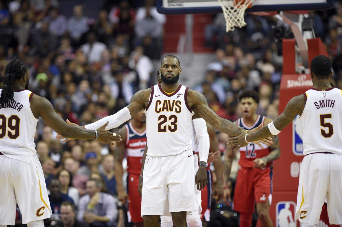 Cleveland Cavaliers forward LeBron James slaps hands with teammates Jae Crowder and JR Smith after he was fouled during the game against the Washington Wizards on Friday. (AP)