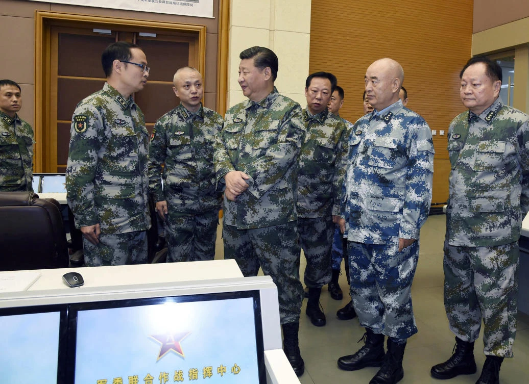 Chinese President Xi Jinping, center, visits the Central Military Commission joint battle command center in Beijing on photo released November 3. Xi is overseeing an ambitious military modernization program, including developing capabilities for China’s forces to operate far from home. (Xinhua via AP)