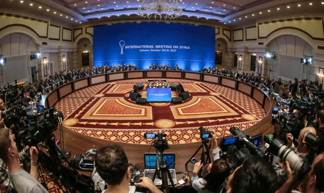Representatives of the Syria regime and rebel groups along with other attendees take part in the session of Syria peace talks in Astana on October 31, 2017. Russia, Turkey and Iran pledged in Kazakhstan to bring the Syrian regime and its opponents together for a "congress" to help nudge peace efforts towards a more lasting political settlement. (AFP)