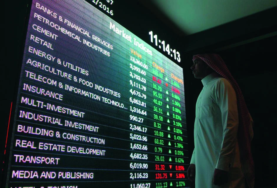 An investor monitors a screen displaying stock information at the Tadawul in Riyadh. (Reuters)
