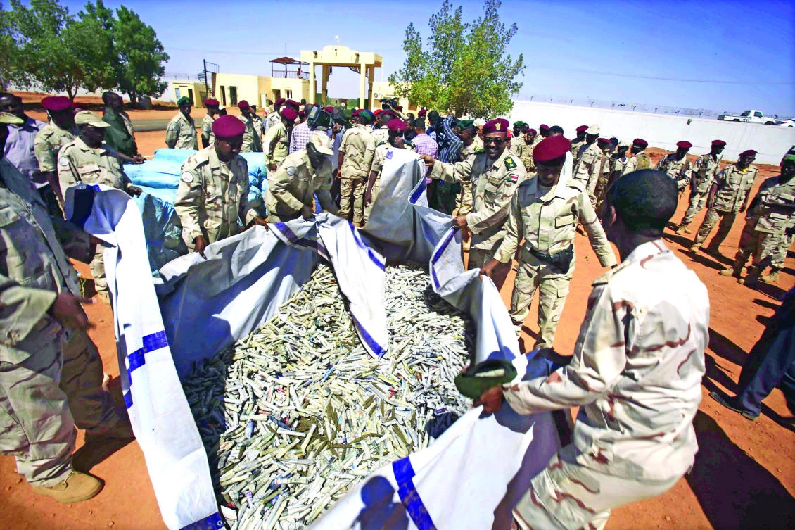 Members of Rapid Support Forces (RSF) show on Sunday sacks of hashish that were captured in the state of South Darfur a week earlier. (AFP)