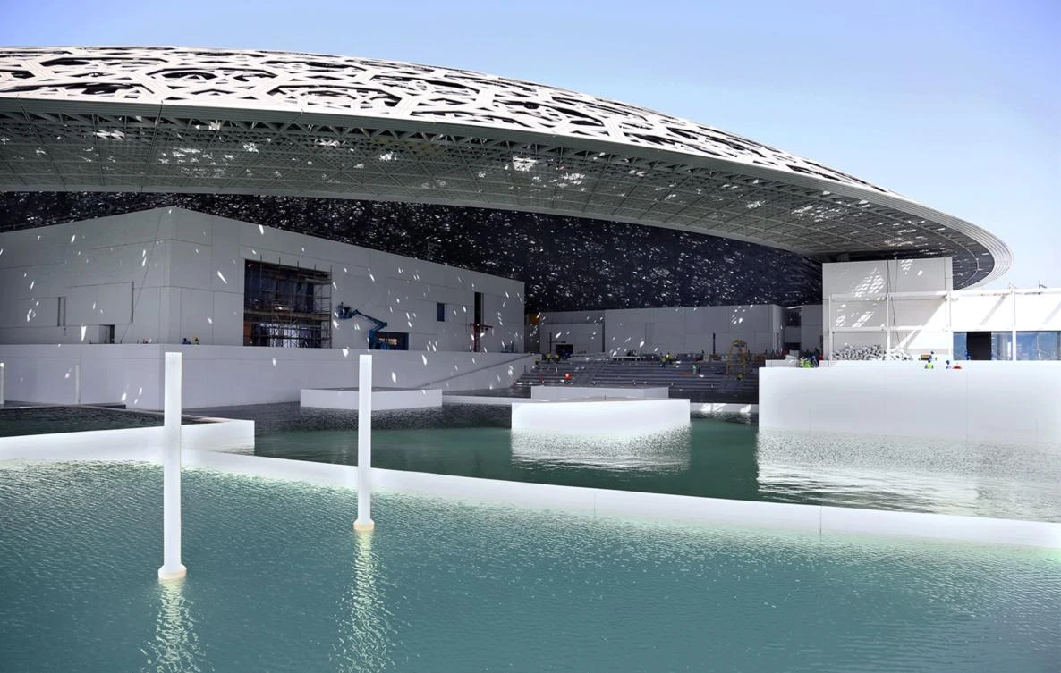 This file handout picture taken on May 24, 2016, and made available on June 15, 2016, by Abu Dhabi’s Tourism Development and Investment Company (TDIC) shows Abu Dhabi’s Louvre museum, designed by French architect Jean Nouvel, surrounded by sea water. (AFP/HO/TDIC)