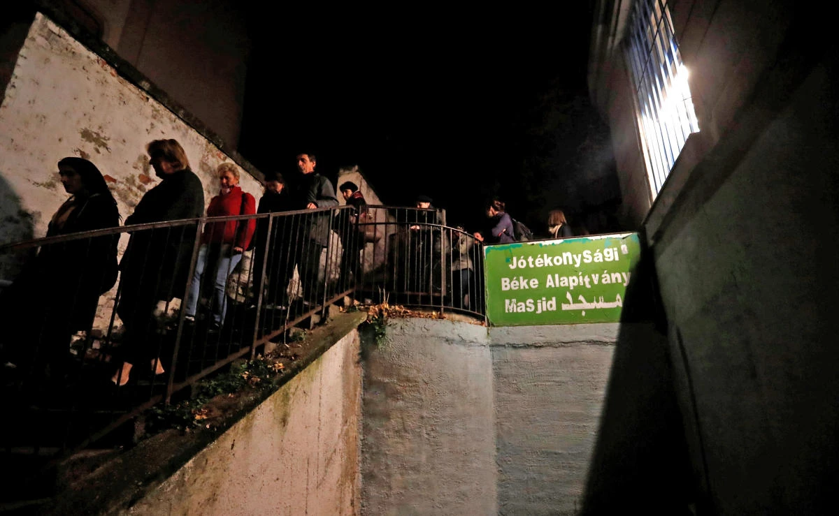 A group of Hungarians who take part in an organized tour to learn about Budapest’s Muslim community, walk out from a small mosque at an apartment building in Budapest, Hungary on Friday, November 3, 2017. (REUTERS)