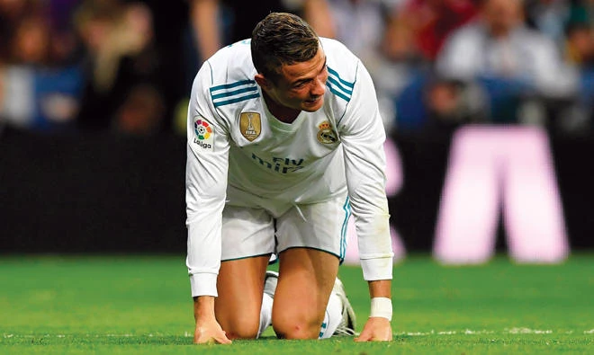 On his knees: Cristiano Ronaldo has been given the week off by his national team. (AP)