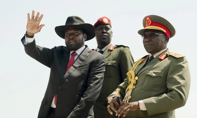 In this file photo, South Sudan's President Salva Kiir, left, accompanied by then army chief of staff Paul Malong, right, waves during an independence day ceremony in the capital Juba, South Sudan. Tensions are high Saturday, Nov. 4, 2017, in Juba after President Salva Kiir sent troops to surround the home of former military chief of staff Paul Malong, disarm his bodyguards and remove all weapons. (AP)
