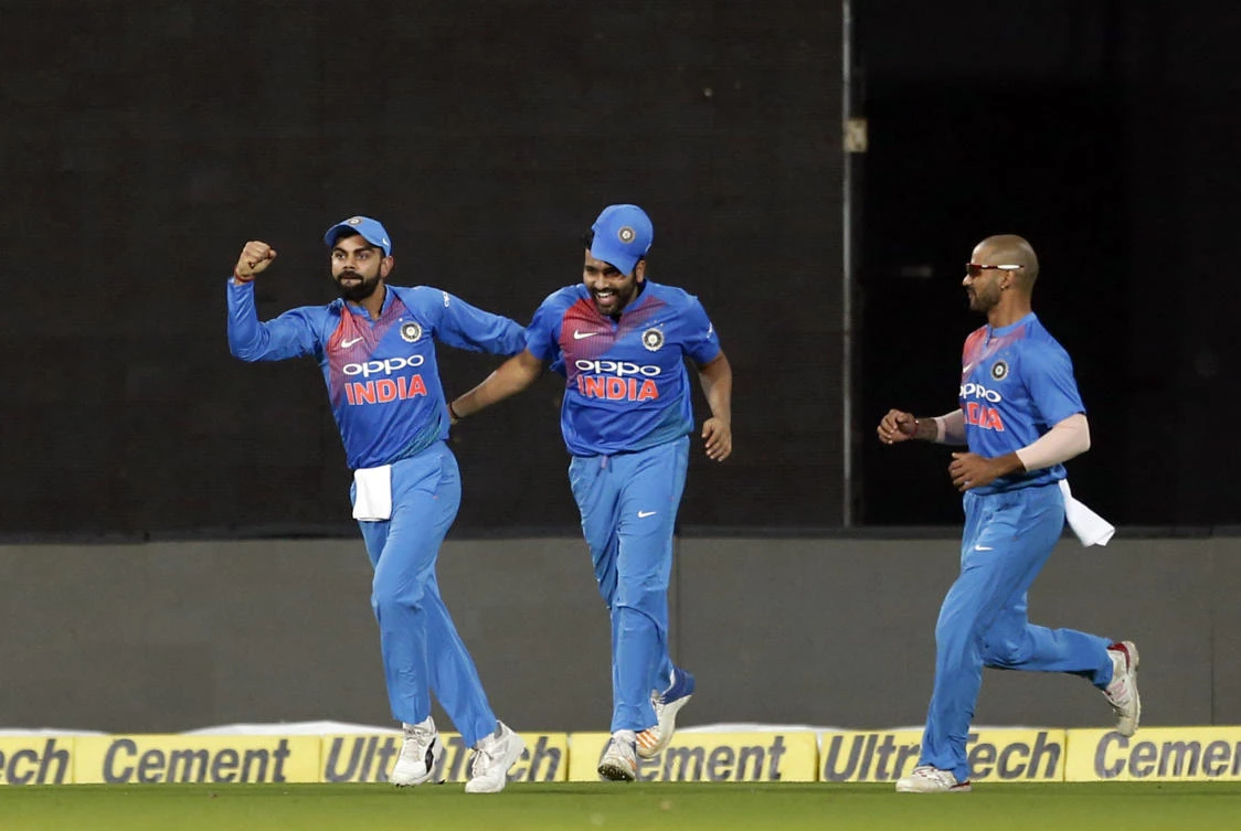 India's Rohit Sharma, center, celebrates with captain Virat Kohli, left, and Shikhar Dhawan. (AP Photo/Aijaz Rahi)