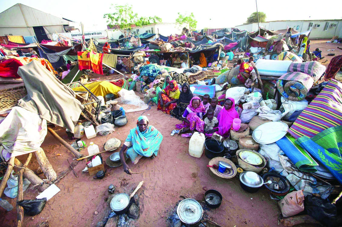 This file photo shows internally displaced persons gathering inside the UN’s mission compound in Khor Abeche, 83 km northeast on Nyala (South Darfur). (AFP)