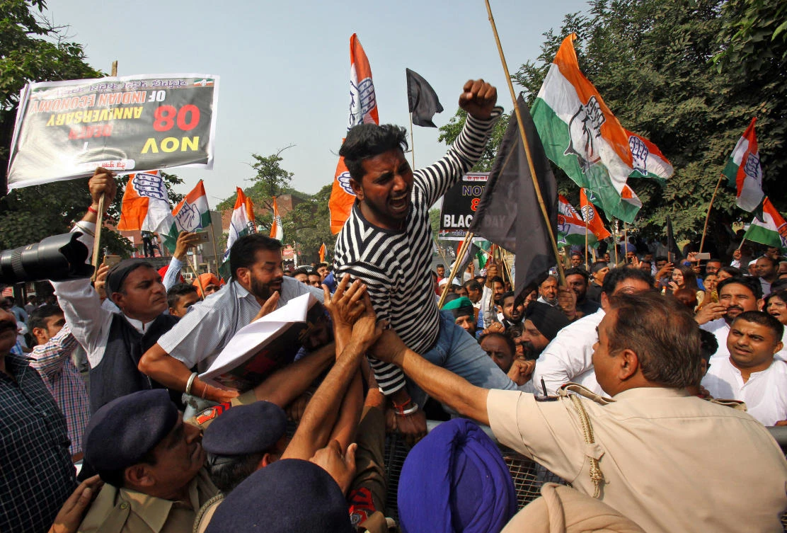 A demonstrator reacts as he is stopped by police during a protest in Chandigarh, organized by India’s main opposition Congress party, to mark a year since demonetization was implemented by Prime Minister Narendra Modi. (Reuters)