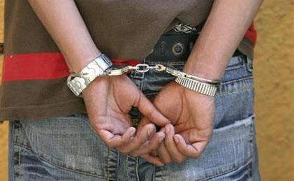 A man is seen with handcuffs in this April 11, 2007 file photo. (File photo by Reuters)