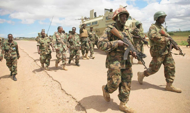 In this file photo, African Union Mission in Somalia (AMISOM) troops walk down the road between Afrgoye and Baidoa after arriving in the town of Afgoye town to the west of the Somali capital, Mogadishu. (Reuters)