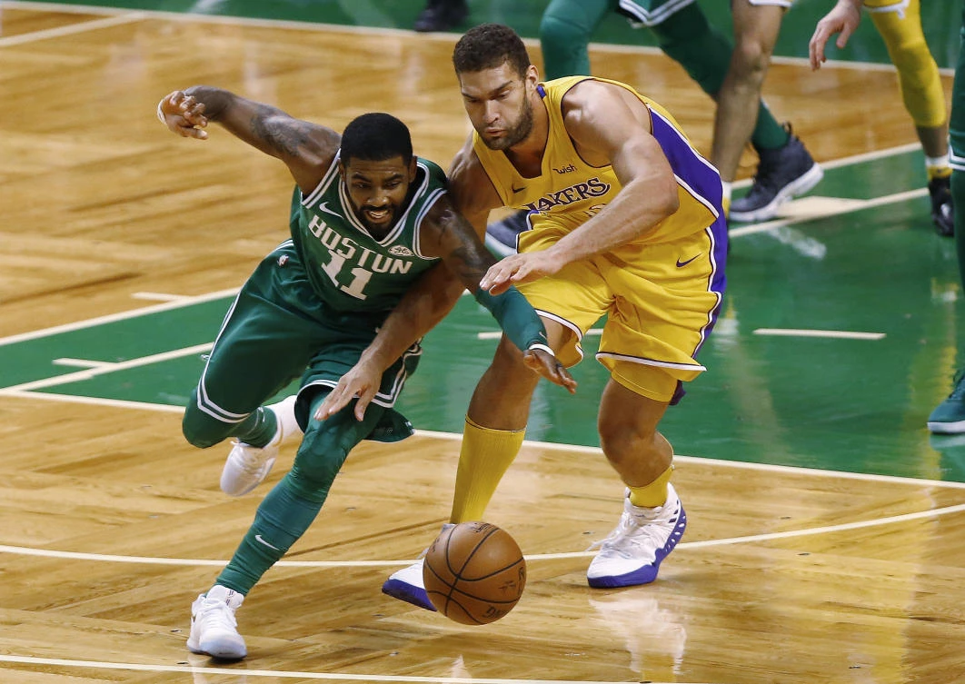 Boston Celtics’ Kyrie Irving, left, and Los Angeles Lakers’ Brook Lopez scramble for the ball during the matchup between two of the NBA’s most storied franchises. (AP)