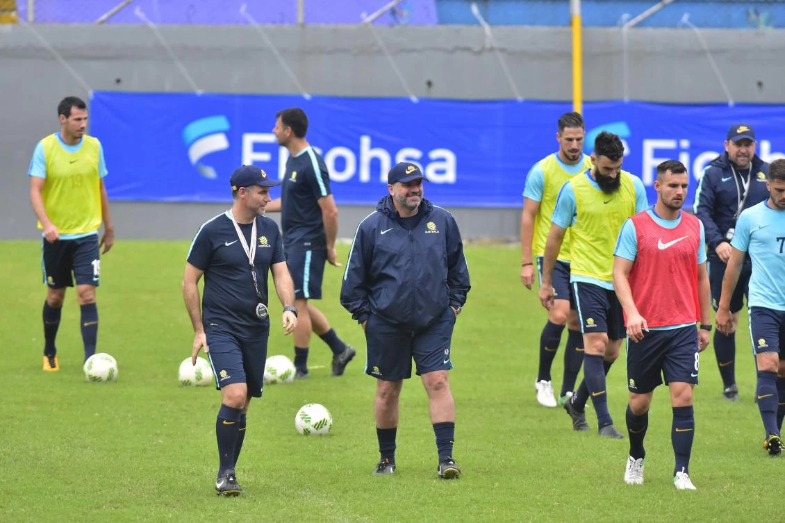 Australia head coach, Ange Postecoglou, center, walks on the field surrounded by his players during a training session at the Francisco Morazan Stadium in San Pedro Sula, Honduras, Tuesday, Nov. 7, 2017. Australia and Honduras will face for the first leg of the World Cup playoff on Friday. (AP)