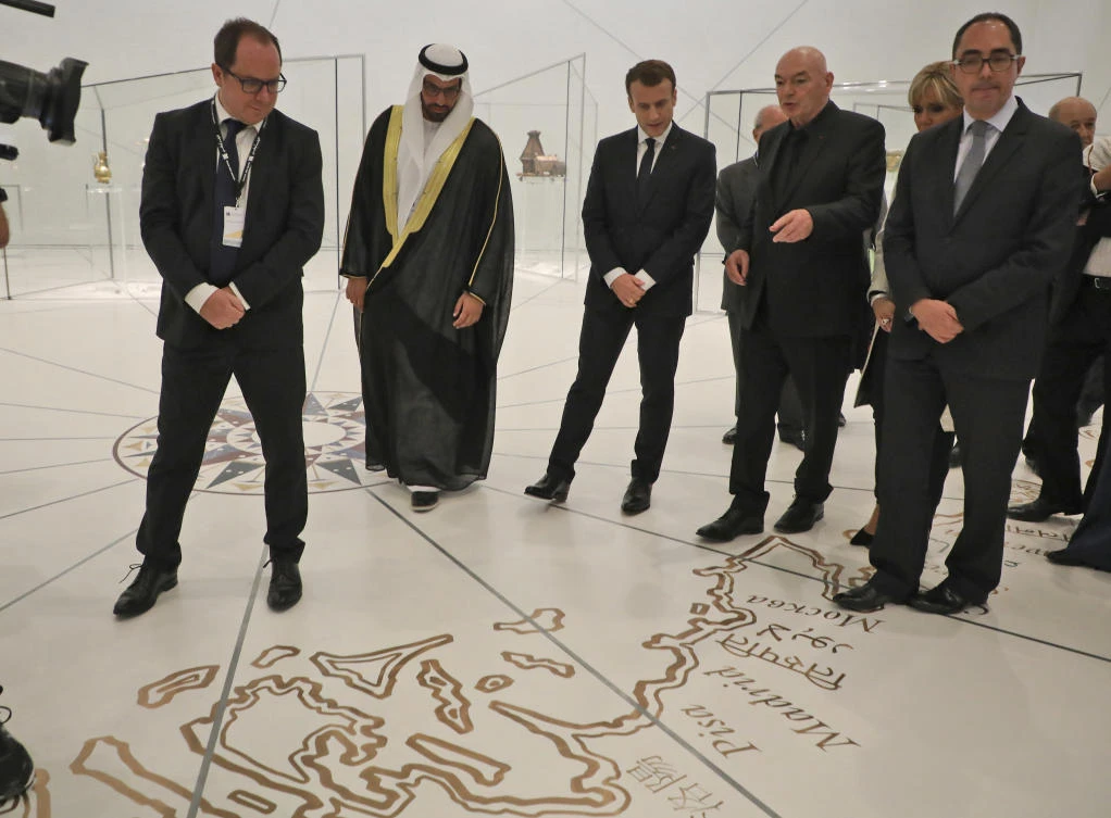 Chairman of Abu Dhabi’s Tourism and Culture Authority, Mohamed Khalifa Al-Mubarak, 2nd left, and French President Emmanuel Macron, center, listen to project designer French architect Jean Nouvel, 2nd right, as they visit the Louvre Abu Dhabi Museum during its inauguration in Abu Dhabi, United Arab Emirates, Wednesday, Nov. 8, 2017. (Ludovic Marin/Pool photo via AP)