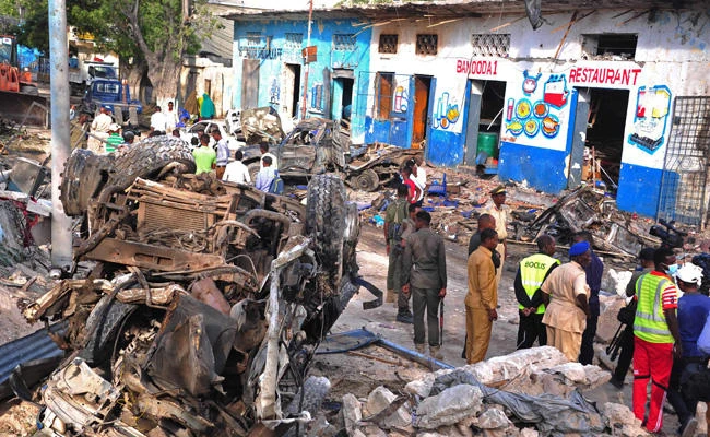 Residents walk at the scene of a blast on October 29, 2017, a day after two car bombs exploded in Mogadishu. On Thursday, a US drone strike killed “several" Al-Shabab militants in Somalia on Thursday afternoon, the US Africa Command said on Friday. (AFP / Mohamed Abdiwahab/File photo)