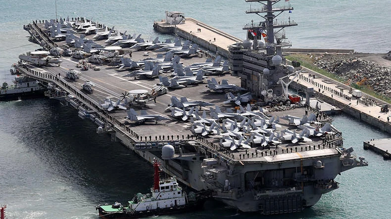 Above, the USS Ronald Reagan aircraft carrier arrives in the South Korean port city of Busan on October 21. The USS Ronald Reagan joins two other flattops — USS Nimitz and USS Theodore Roosevelt — in a four-day joint exercise in the western Pacific. (Yonhap/AFP)